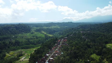 Aerial-Orbit-Exploring-the-Breathtaking-Views-of-the-Vast-Beauty-in-Sideman-with-a-Village-Below,-Bali,-Indonesia