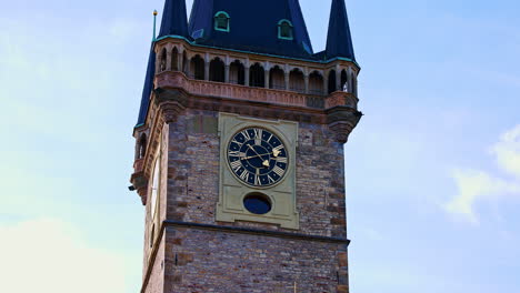 Gothic-tower-with-golden-clock-against-blue-sky,-Prague-clock-tower