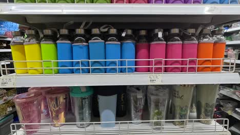 In-the-following-shot,-colorful-and-designable-water-bottles-are-displayed-for-sale-in-the-supermarket