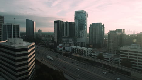 A-nearly-empty-Katy-Freeway-overlooking-downtown-Houston,-Texas-at-sunset