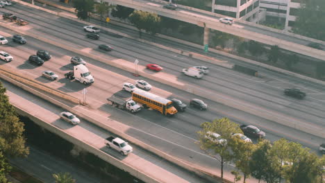 Morning-traffic-slow-down-on-the-Katy-freeway-near-downtown-Houston,-Texas,-school-bus-and-trucks