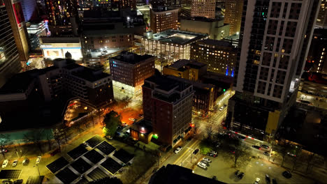 Aerial-birds-eye-flight-over-lighting-city-of-Atlanta-with-ferris-wheel-in-Downtown-at-midnight