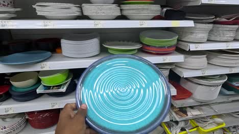 POV-shot,-customer-buying-ceramic-dishes-at-shopping-mall