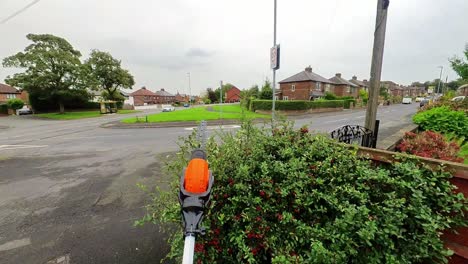 POV-male-doing-chores-landscaping-overgrown-hedge-leaves-with-electrical-garden-shears