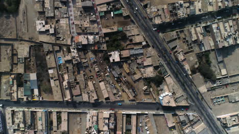 Aerial-birds-eye-shot-above-the-streets-of-Huacho-city,-sunny-day-in-Peru
