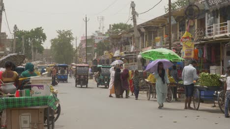 Crowded-Indian-street-during-summer-heat-wave-and-wind-storm,-Cyclone-Biparjoy-effort-in-Bihar