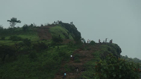 Tourists-admiring-scenery-from-top-of-hill-on-cloudy-day,-Gujarat,-India