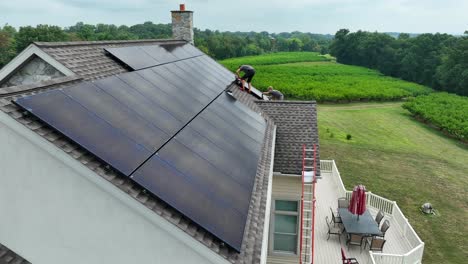 Male-workers-on-residential-shingle-roof-installing-solar-panels