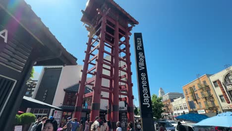 Look-up-shot-at-Little-Tokyo-Watchtower-and-Japanese-Village-Plaza-Sign,-Los-Angeles-Downtown