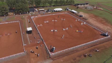 Aerial-View-of-Thrilling-Horse-Jumping-Event,-Showjumping-event-in-the-horse-jumping-Barn