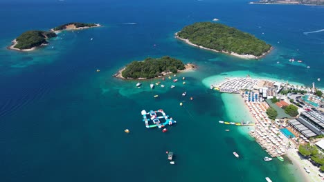 Three-Islands-of-Ksamil,-Lagoon-Azure-Sea,-White-Sand-Beach,-Summer-Holiday,-Swimming,-Sunbathing,-Boats,-and-Paradise-Getaway