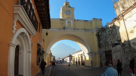 Handheld-static-view-of-Guatemala-Volcano-framed-by-yellow-colonial-arch