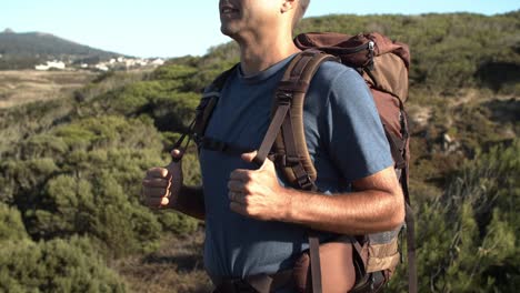 Cropped-shot-of-man-wearing-camping-backpack