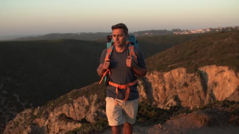 Active-male-tourist-walking-along-cliff