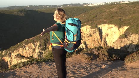 Excited-woman-wearing-camping-backpack
