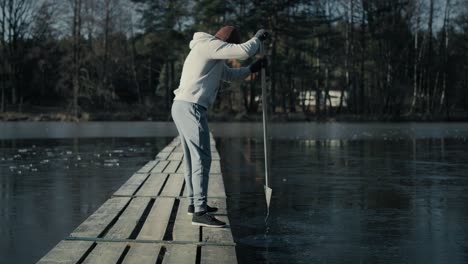 Caucasian-adult-man-preparing-for-swimming-in-frozen-lake.