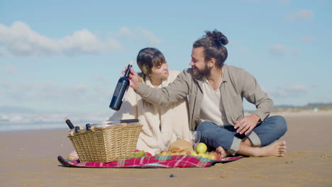 Romantic-Caucasian-couple-enjoying-picnic-at-the-beach