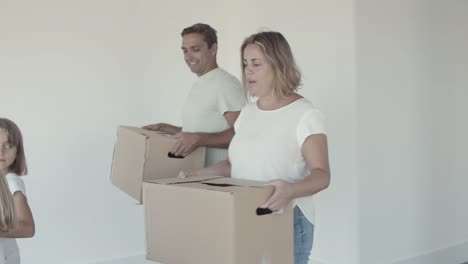 Family-couple-and-two-kids-moving-into-new-apartment
