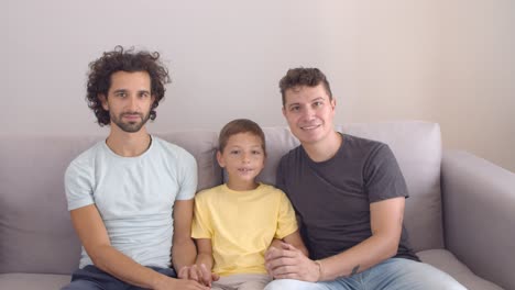 Happy-handsome-gay-parents-and-son-posing-at-home