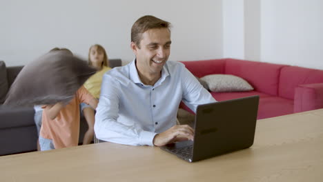 Cheerful-father-looking-at-laptop-screen