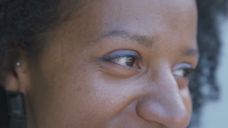 Closeup-of-womans-eyes-looking-at-camera,-turning-head-aside
