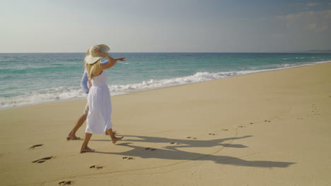 Beautiful-happy-couple-in-love-walking-on-beach