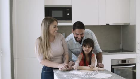 Joyful-family-couple-and-little-kid-applying-flour-on-faces