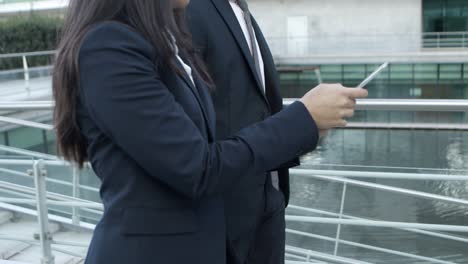 Cropped-shot-of-business-colleagues-with-tablet-pc-on-street