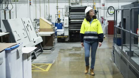 Front-view-of-female-engineer-walking-at-factory