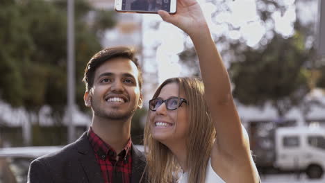 Happy-young-couple-taking-selfie-with-smartphone