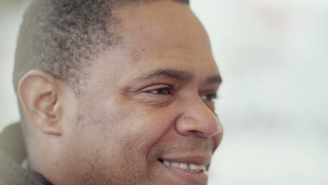 Close-up-shot-of-Afro-American-middle-aged-mans-face-smiling-and-laughing