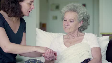 Smiling-nurse-giving-pills-to-senior-woman-at-home.