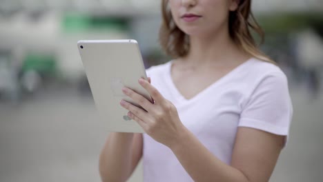 Cropped-shot-of-young-woman-using-tablet