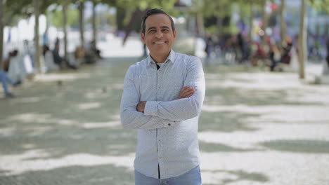 Handsome-Hispanic-man-smiling-at-camera-outdoor