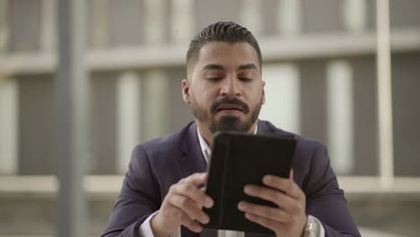 Businessman-talking-and-using-digital-tablet