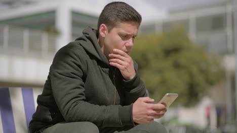 Thoughtful-man-using-cell-phone-outdoor
