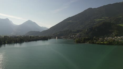 Aerial-footage-of-serene-mountain-lake-near-a-Swiss-village