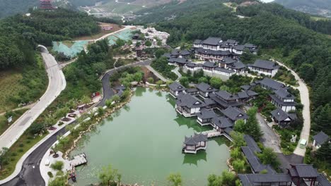 Aerial-static-drone-shot-of-beautiful-traditional-buildings-in-classical-chinese-architecture-overlooking-the-lake-and-a-beautiful-chinese-landscape