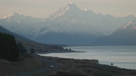 Static-shot-of-cars-driving-through-the-Mount-Cook-mountain-valley-during-winter