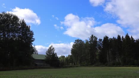 timelapse-video-of-farm-scenery-with-old-barn,-forest-and-field