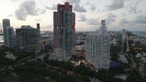Panoramic-aerial-view-of-South-Beach-Miami-oceanside-skyline-buildings-under-at-sunset