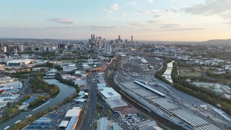 Establishing-stationary-drone-shot-of-Brisbane-City,-shot-during-sunset,-flying-over-the-inner-city-bypass-ICB-road-network