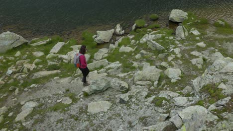 Woman-Trekking-On-Rocky-Trail-By-The-Campagneda-Lake-In-Valmalenco,-Italy