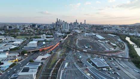 Establishing-static-stationary-drone-shot-of-Brisbane-City,-shot-during-sunset,-flying-over-the-inner-city-bypass-ICB-road-network