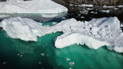 Massive-iceberg-bellow-ocean-water,-aerial-drone-view