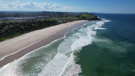 Foamy-Waves-Crashing-On-Sandy-Shore-In-Sharpes-Beach,-New-South-Wales,-Australia---aerial-shot