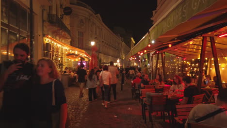 Old-town-streets-with-tourists-at-night,-Bucharest,-Romania