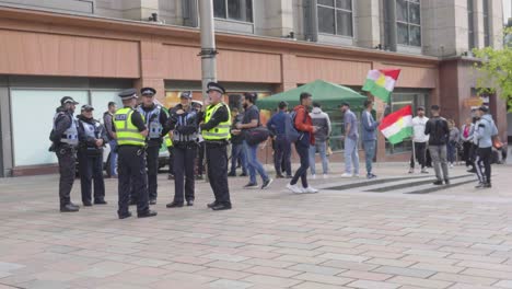 Young-men-gather-to-demonstrate-waving-Kurdistan-flags-while-Police-watch-on