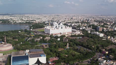 Aerial-footage-of-the-entire-Hussain-Sagar-Lake-and-the-Telangana-Secretariat,-Ambedkar-statue-and-Martyrs-Memorial-situated-on-Hyderabad-roads-are-used-by-vehicles-at-the-Morning