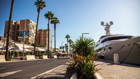 People-walking-by-yachts-at-the-Port-of-Malaga,-Spain---time-lapse